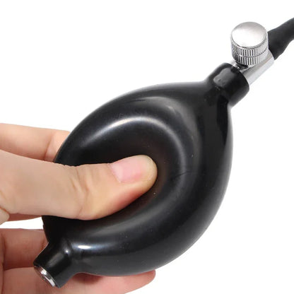 Hand pressing black air pump bulb with metal valve, fitness gear accessory