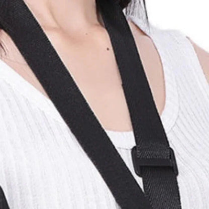 Black strap over a person wearing a white top on a light gray background