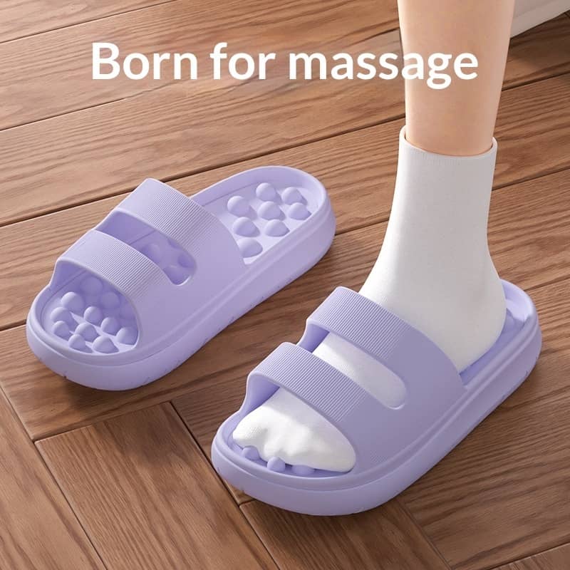 Purple massage slippers on a wooden floor with text 'Born for massage'.