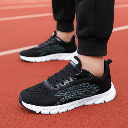 Black running shoes with white soles on a red track