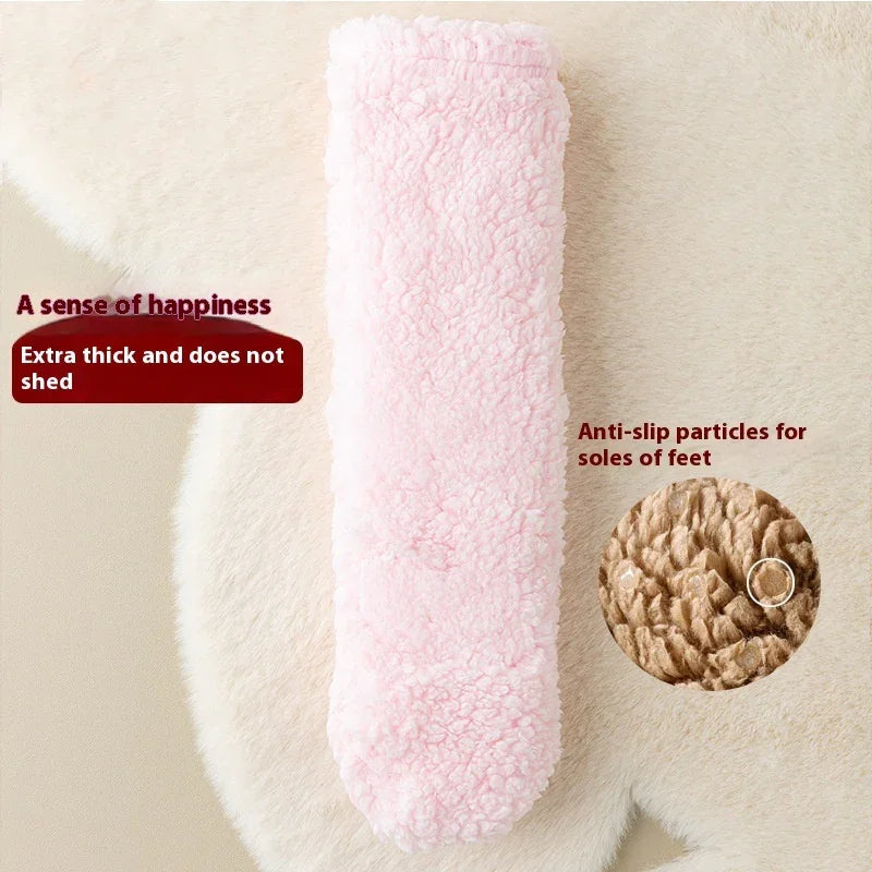 Pink thick fuzzy sock with anti-slip sole particles on a cream background, cozy fitness accessory.