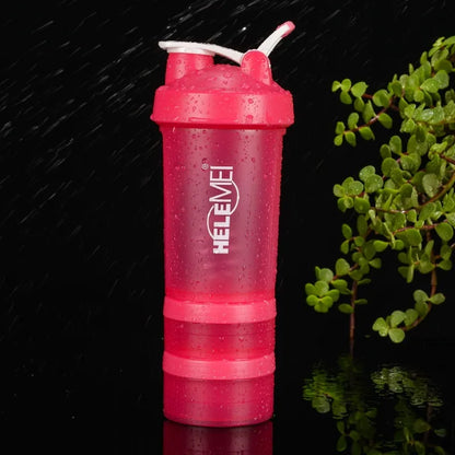Pink HELEME shaker bottle with a plant in the background