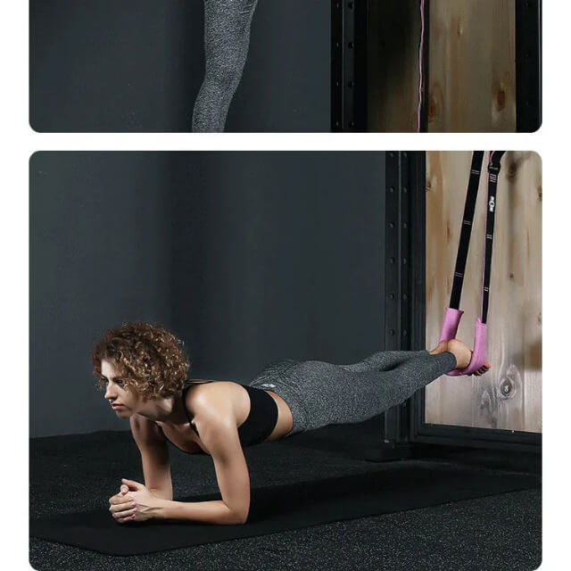 Woman performing suspension strap plank exercise in gym, wearing sportswear on black mat