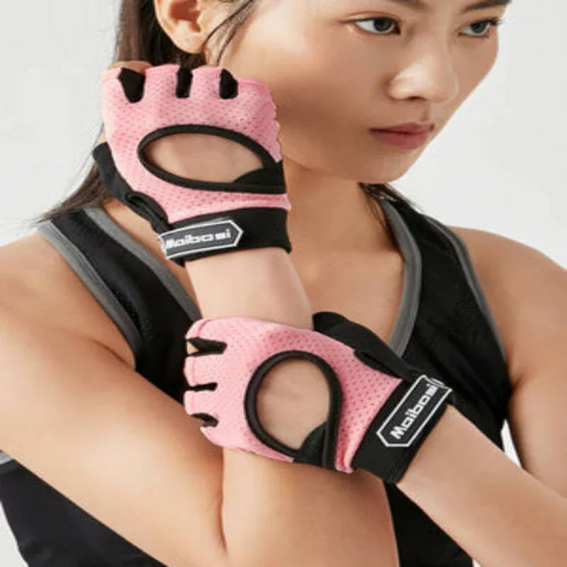 Woman wearing pink fitness gloves with black accents on a white background