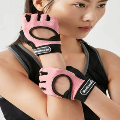 Woman wearing pink fitness gloves with black accents on a white background