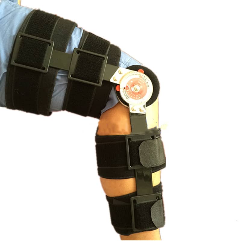 Black knee brace with a label on a white background