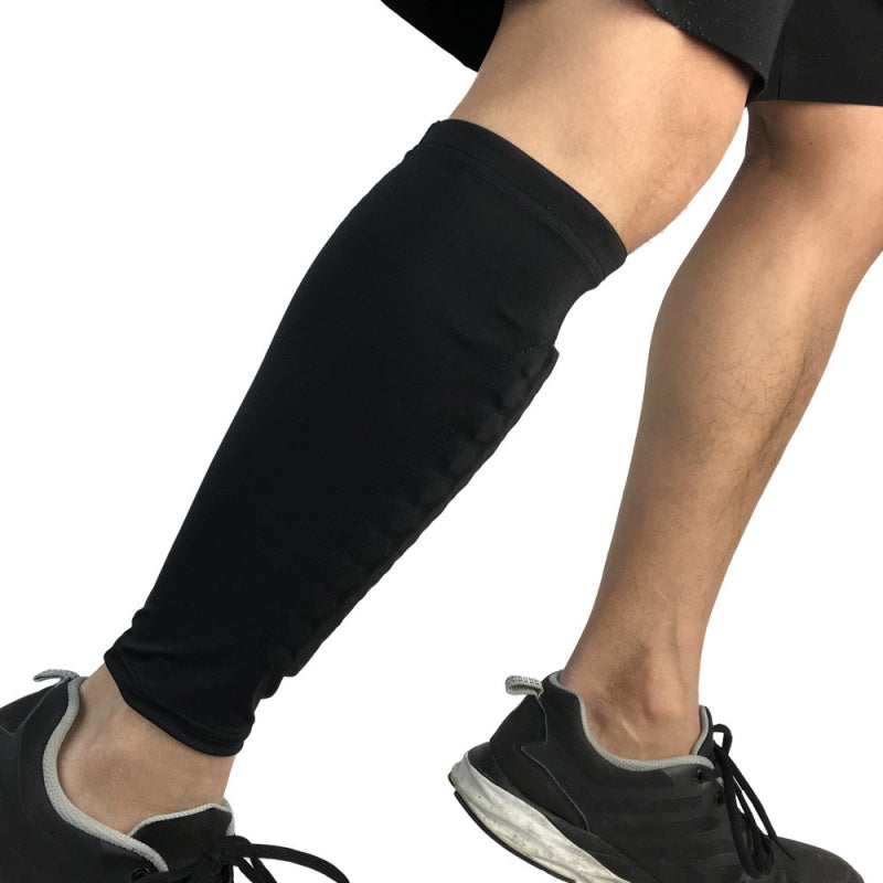 Person wearing black leg sleeves and black shoes on a white background