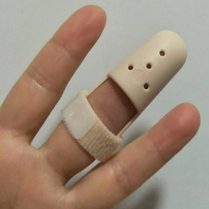 Beige plastic device on a finger against a plain background