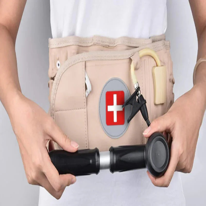 Person wearing a medical belt with a red cross symbol, holding a black device.
