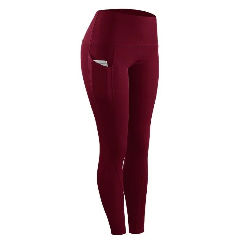 Maroon high-waisted fitness leggings with side pocket holding a phone, ideal for workouts
