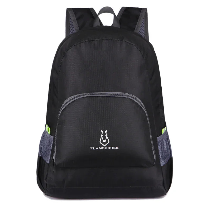 Black lightweight backpack with front zipper pocket and side mesh pockets, outdoor gear