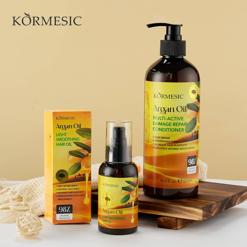 Kormesic Argan Oil hair care products on a wooden tray with a beige background