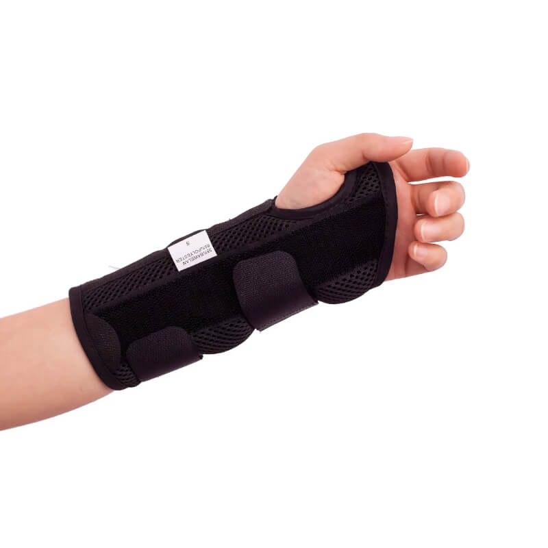 Black wrist brace on a person's wrist with a white background