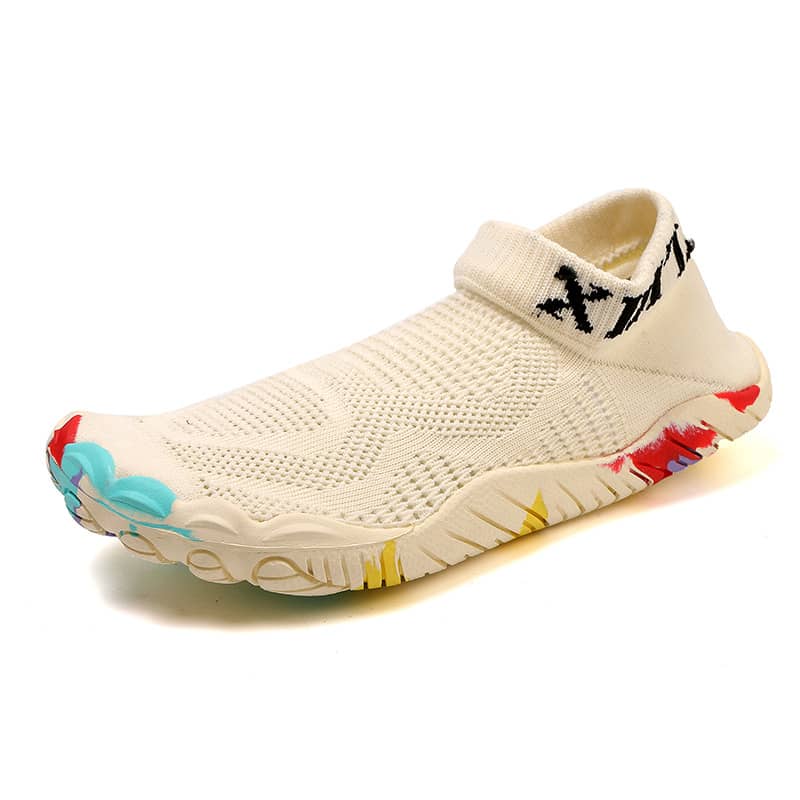 Beige slip-on shoe with colorful sole on a white background