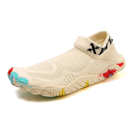Beige slip-on shoe with colorful sole on a white background