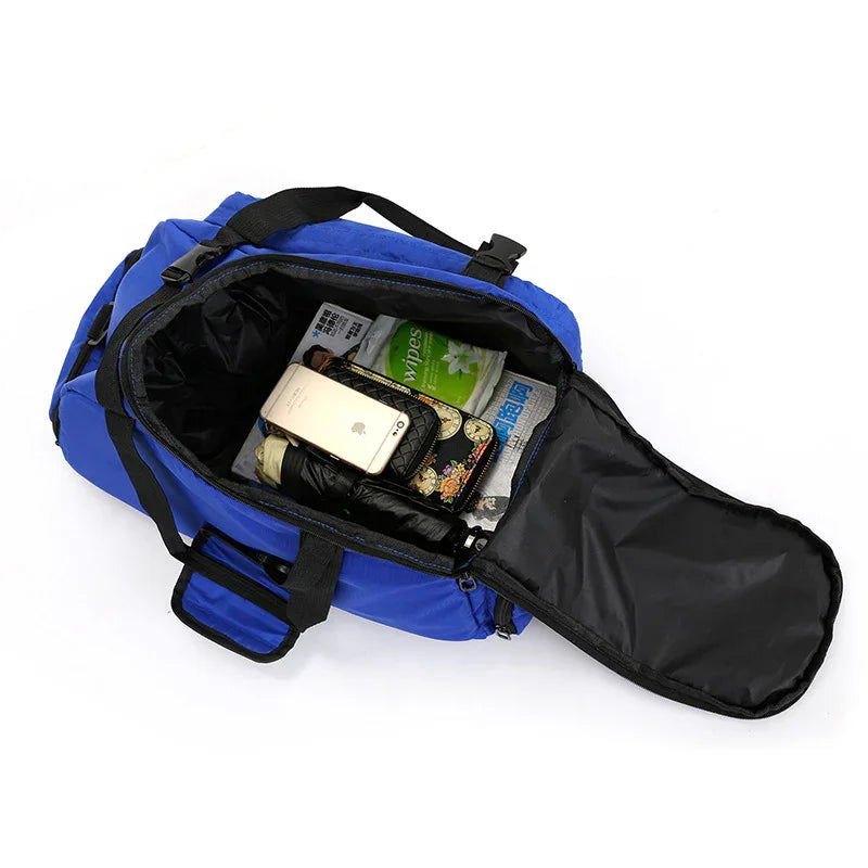 Open blue gym bag with phone, wipes, umbrella and essentials inside on white background