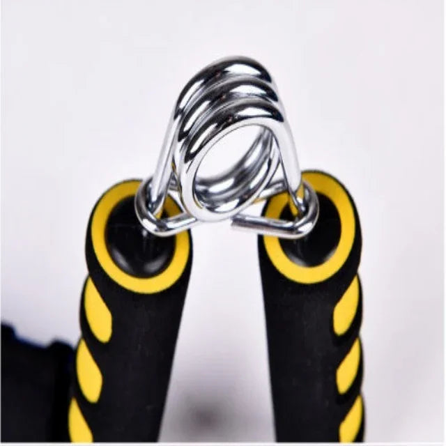 Close-up of black and yellow hand grip strengthener with silver metal spring for fitness training