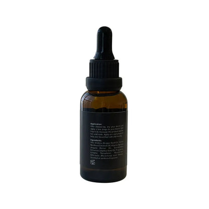 An amber glass dropper bottle with a black cap and black label, shown from the back on a plain white background.
