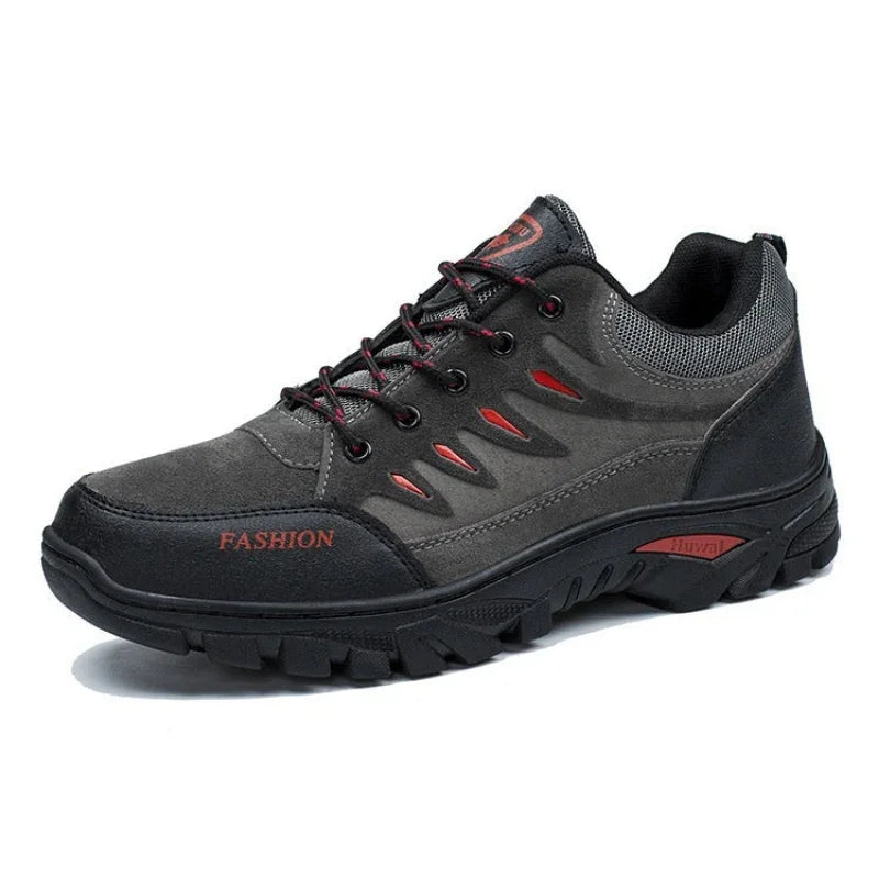 Black and gray outdoor hiking shoe with red accents and rugged non-slip sole