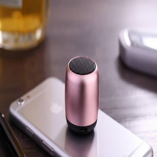 Small pink and black speaker on a smartphone with a blurred background