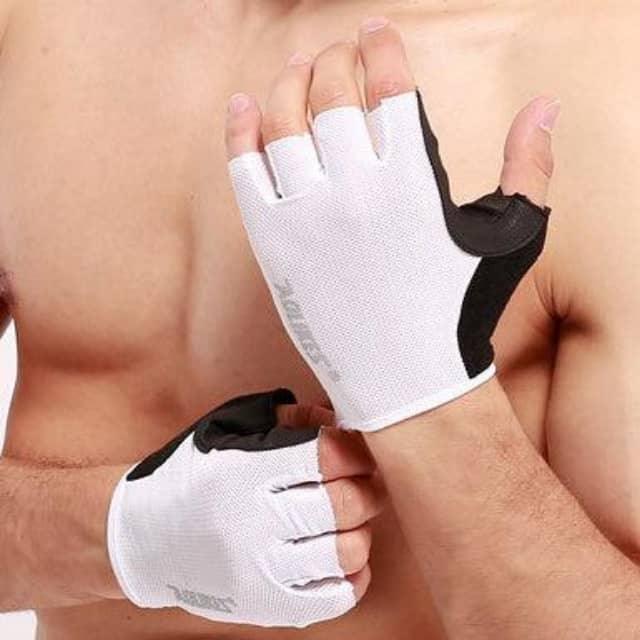 Man wearing white and black fingerless fitness gloves for weightlifting or gym workouts