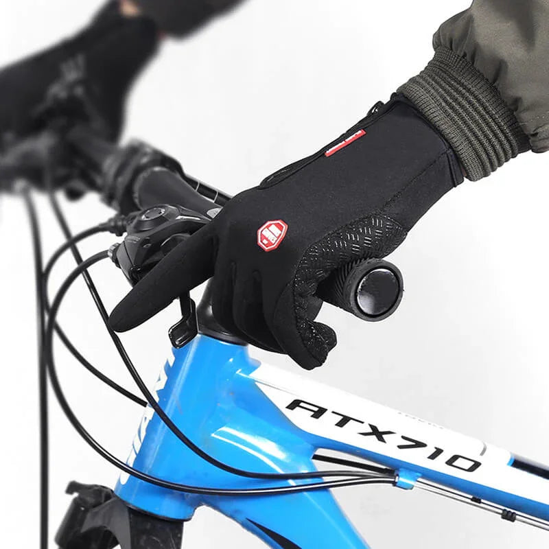 Cyclist wearing black gloves gripping blue ATX710 mountain bike handlebar