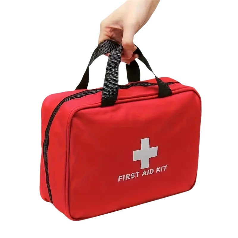 Red first aid kit with a white cross symbol on a white background
