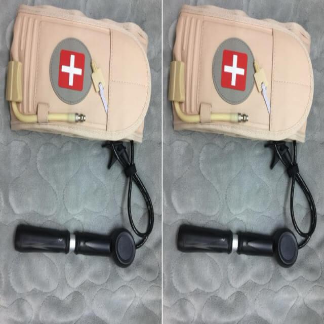 Two views of a medical device with a bandage-like cover on a textured gray background.
