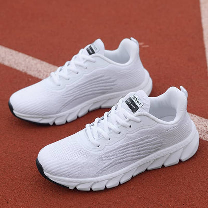 White running shoes on a red track background