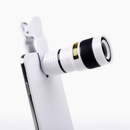 Phone with a white phone clip and black and gold lens attachment on a white background