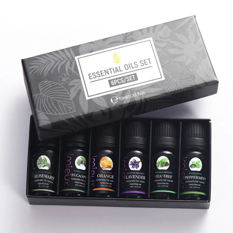 Set of essential oils in a decorative box with labels on a white background