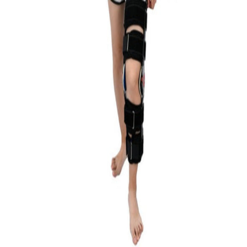 Black knee brace on a mannequin leg against a white background