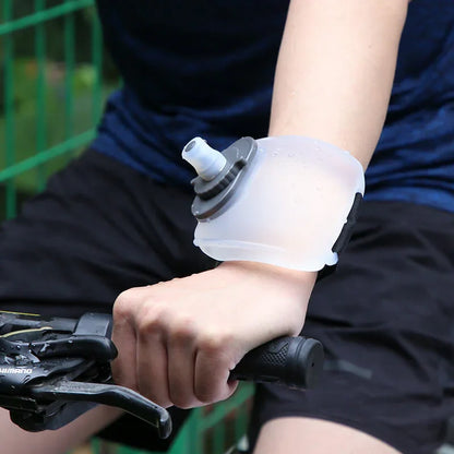 Cyclist wearing a portable wrist water bottle, ideal for fitness and outdoor hydration