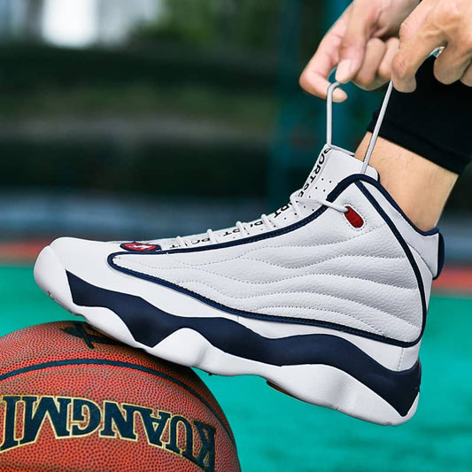 White high-top sneaker with blue accents being worn, on a basketball court.