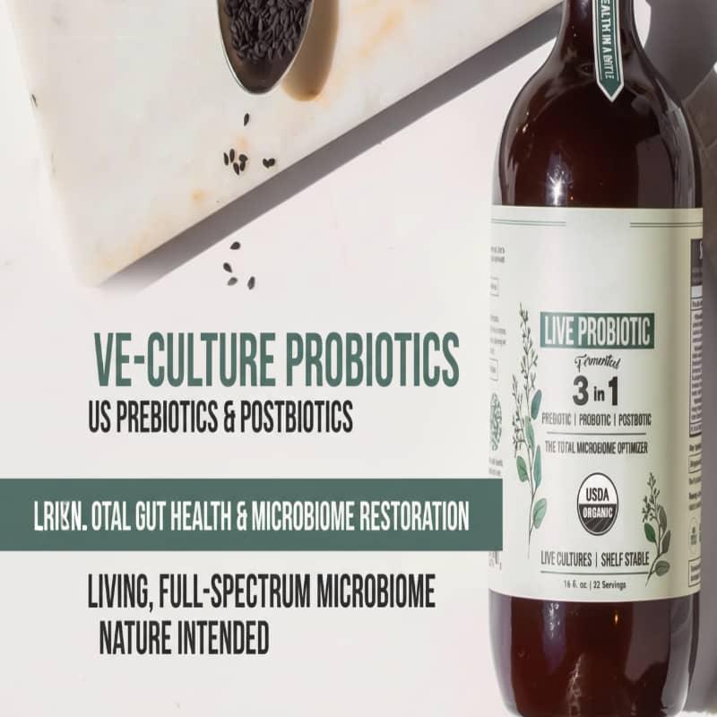 Bottle of live probiotic supplement on marble with seeds, promoting gut health and microbiome support.