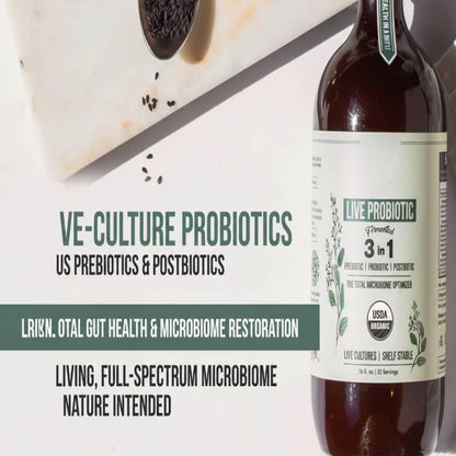 Bottle of live probiotic supplement on marble with seeds, promoting gut health and microbiome support.