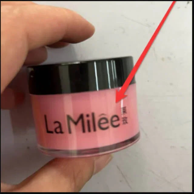 Hand holding pink La Milée cosmetic jar with black lid, labeled in English and Chinese.
