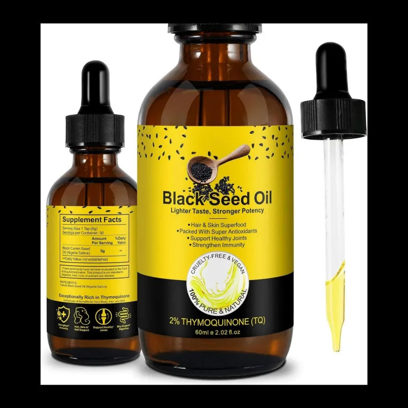 Two amber glass dropper bottles of black seed oil with yellow labels, shown on a plain white background. The center bottle is larger and labeled 'Black Seed Oil' with additional text including 'Lighter Taste, Stronger Potency' and '2% Thymoquinone (TQ)'.