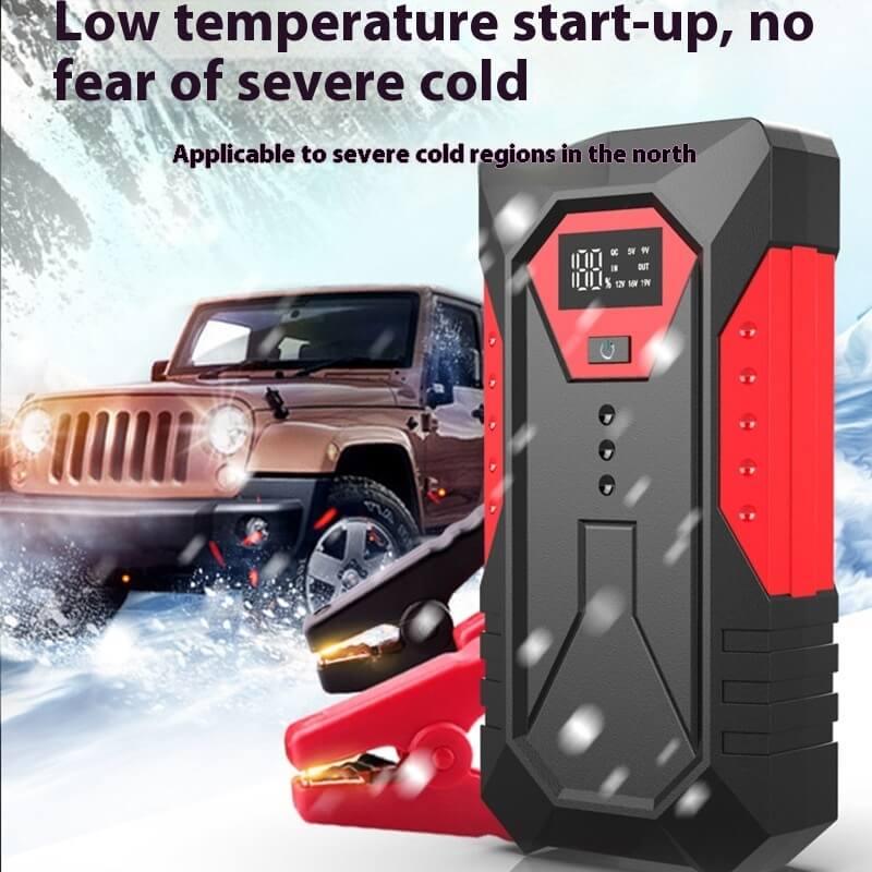 Portable car battery jump starter for cold weather with SUV in snowy mountain setting