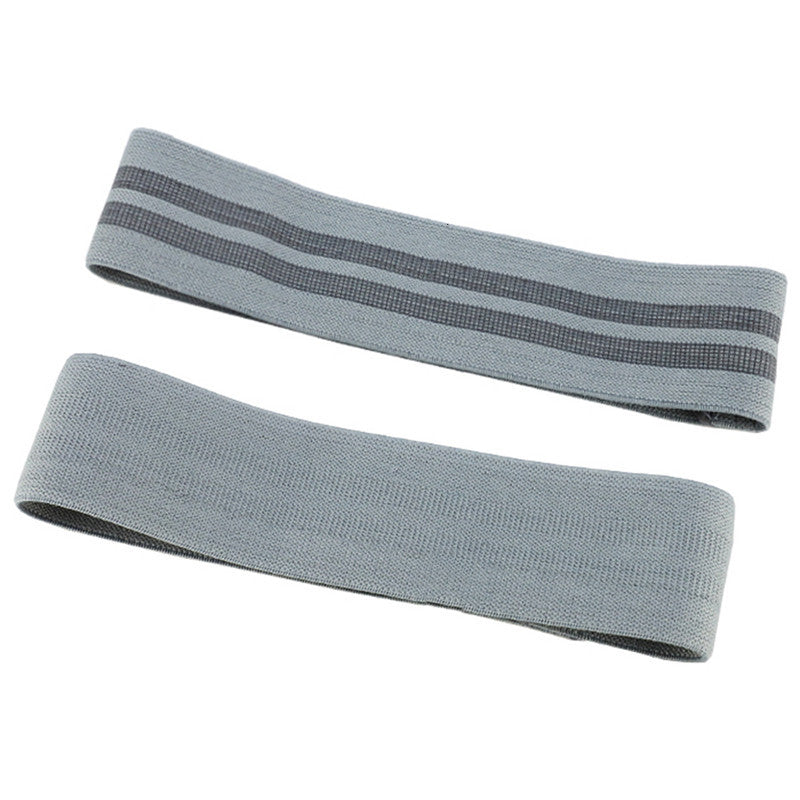 Two gray resistance bands on a white background