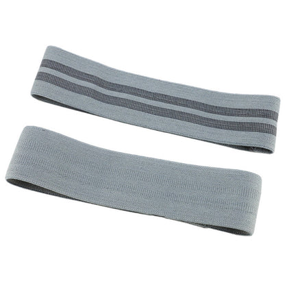 Two gray resistance bands on a white background