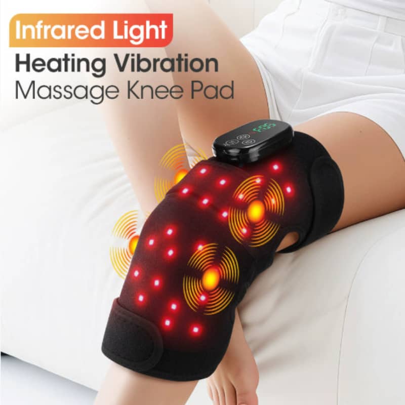 Infrared light heating vibration massage knee pad on a person's knee with indicating features.