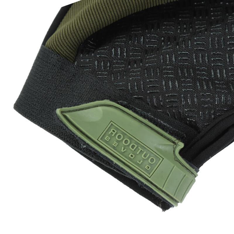 Close-up of black and green outdoor sports glove with textured grip and adjustable strap