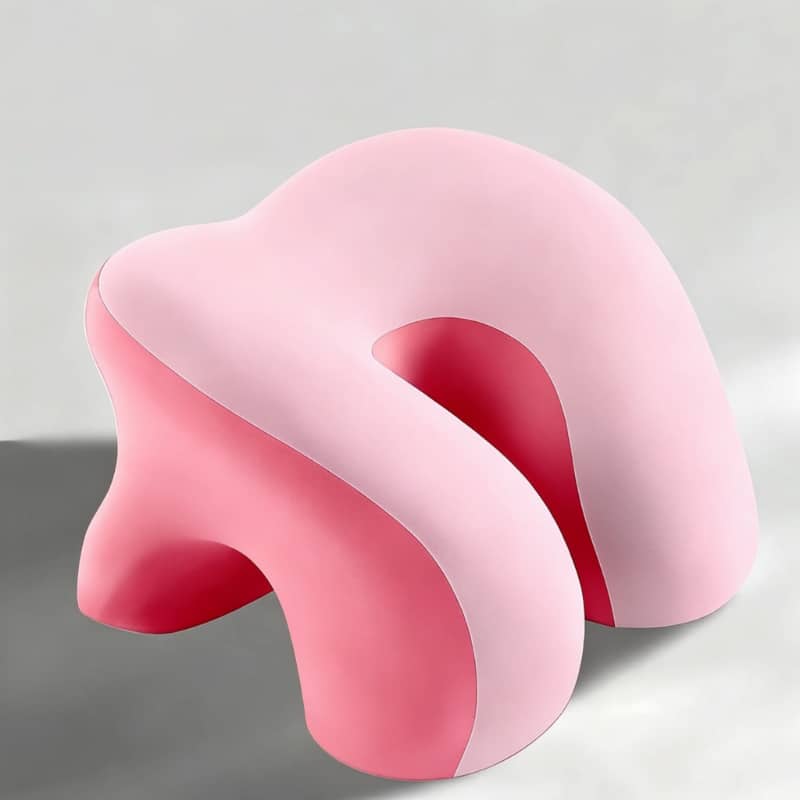 Pink U-shaped neck pillow on a light gray background