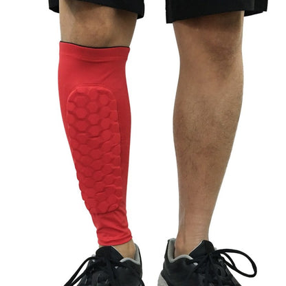Red shin guard on a person's leg with a white background