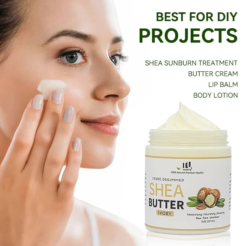 Woman applying shea butter cream to her face with a jar of shea butter in the foreground.
