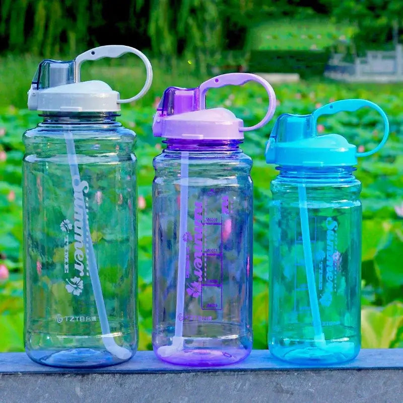 Three colorful plastic sports water bottles with straws outdoors on a stone ledge, Hi Fitness gear