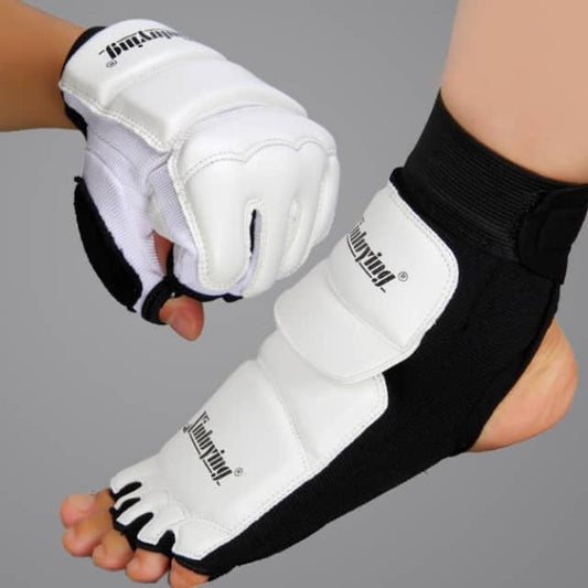 White and black athletic gloves and foot guards with brand logo on a gray background