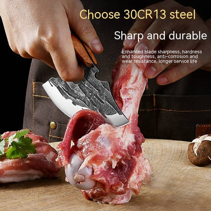 Hand using sharp 30CR13 steel kitchen knife to cut raw meat on a wooden cutting board