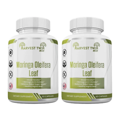 Two white plastic bottles of Harvest Twin Labs Moringa Oleifera Leaf dietary supplement, side by side on a white background.